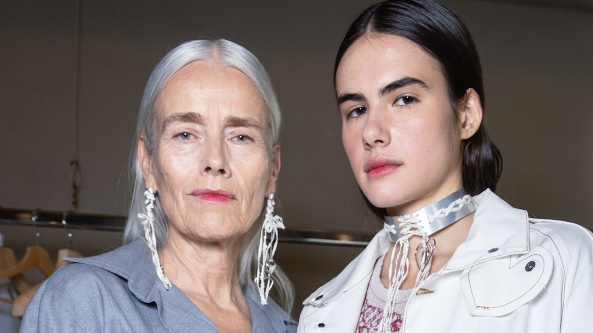 An older and younger model with the same pink lipstick backstage at Marco Rambaldi