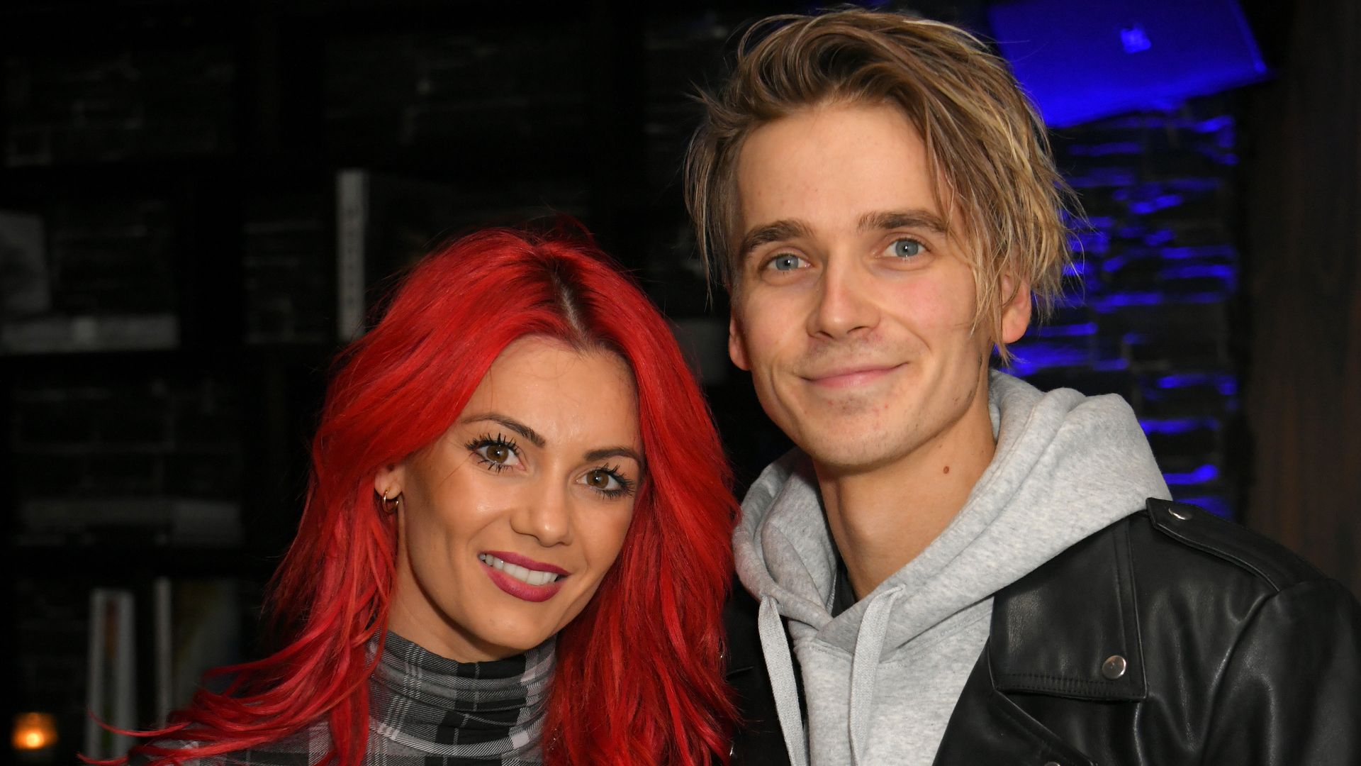 Dianne Buswell and Joe Sugg holding glasses