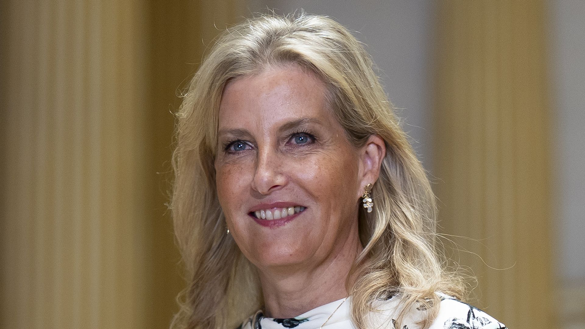 The Duchess of Edinburgh smiling in black and white floral dress