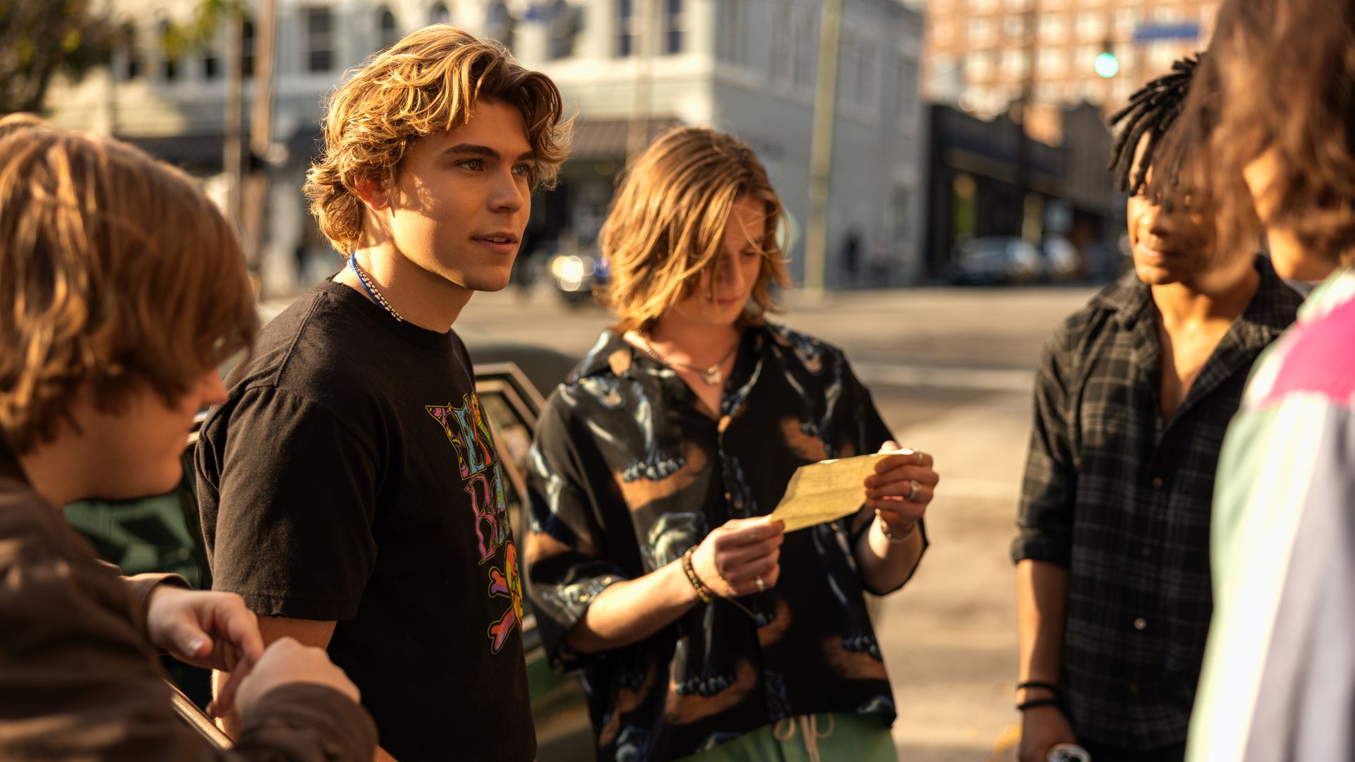 group of teen boys standing on street