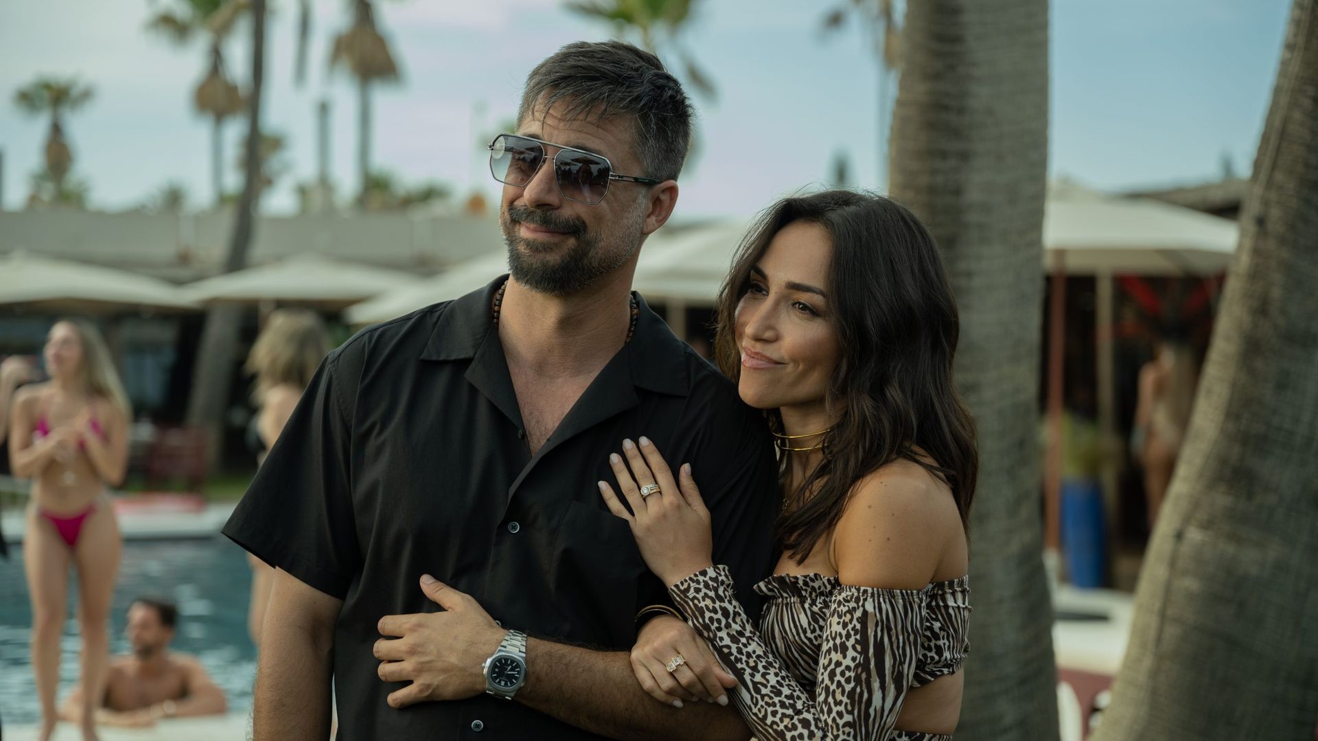 man and woman in holiday resort by pool