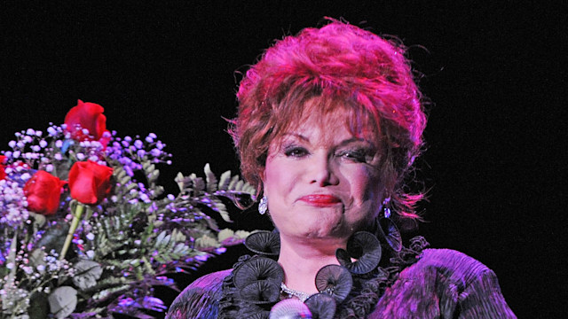 Connie Francis performing next to a bouquet of flowers