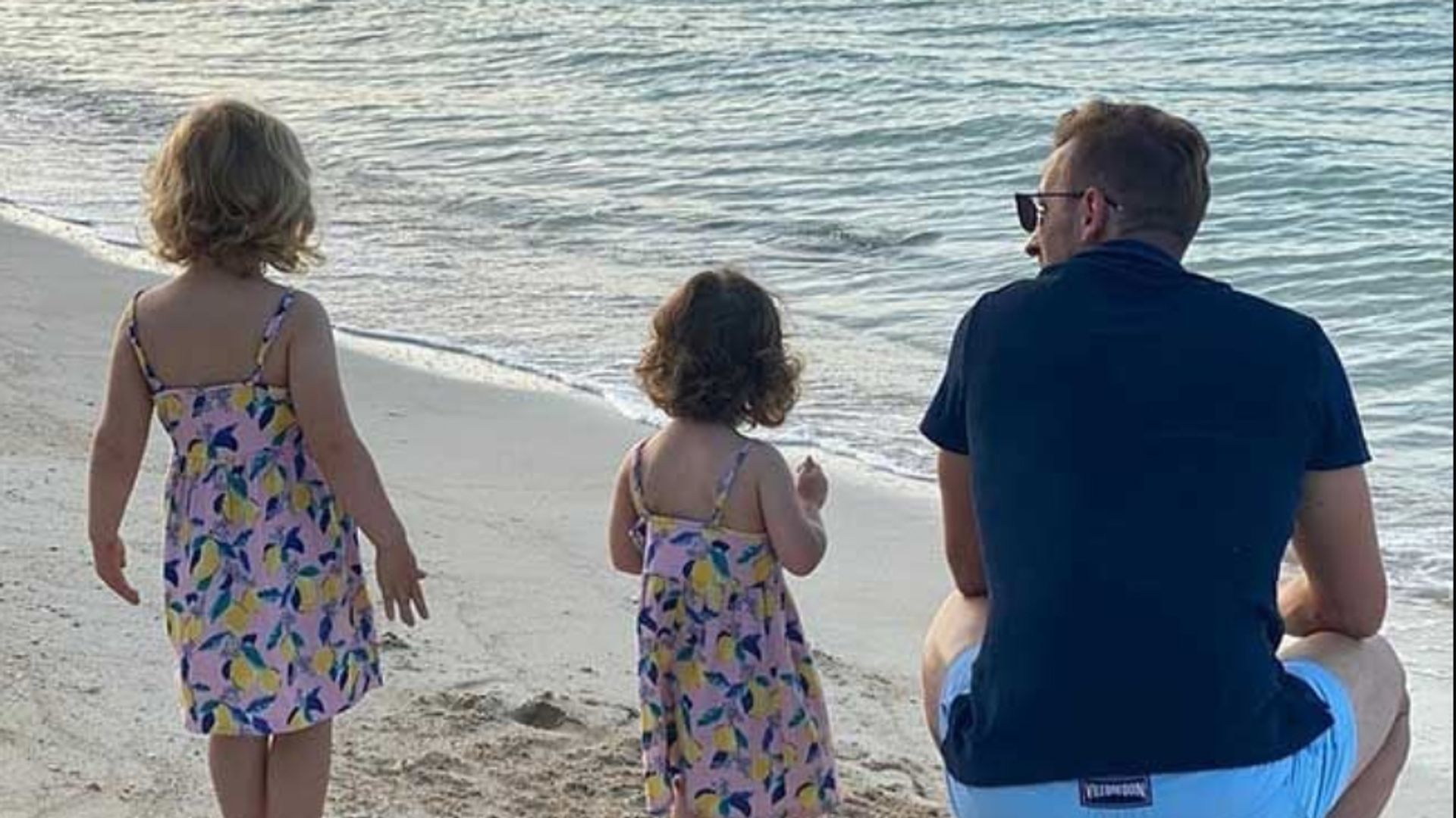 Two young girls and Harry Kane on the beach