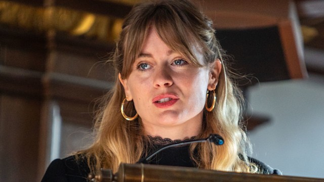 Cressida Bonas reading from a lecturn