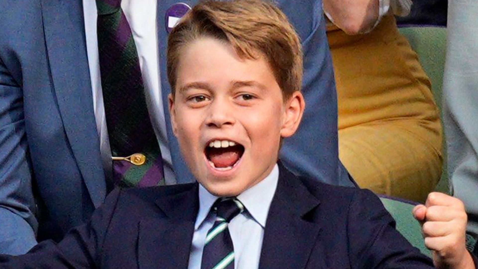 Prince George celebrating with his hands in the air