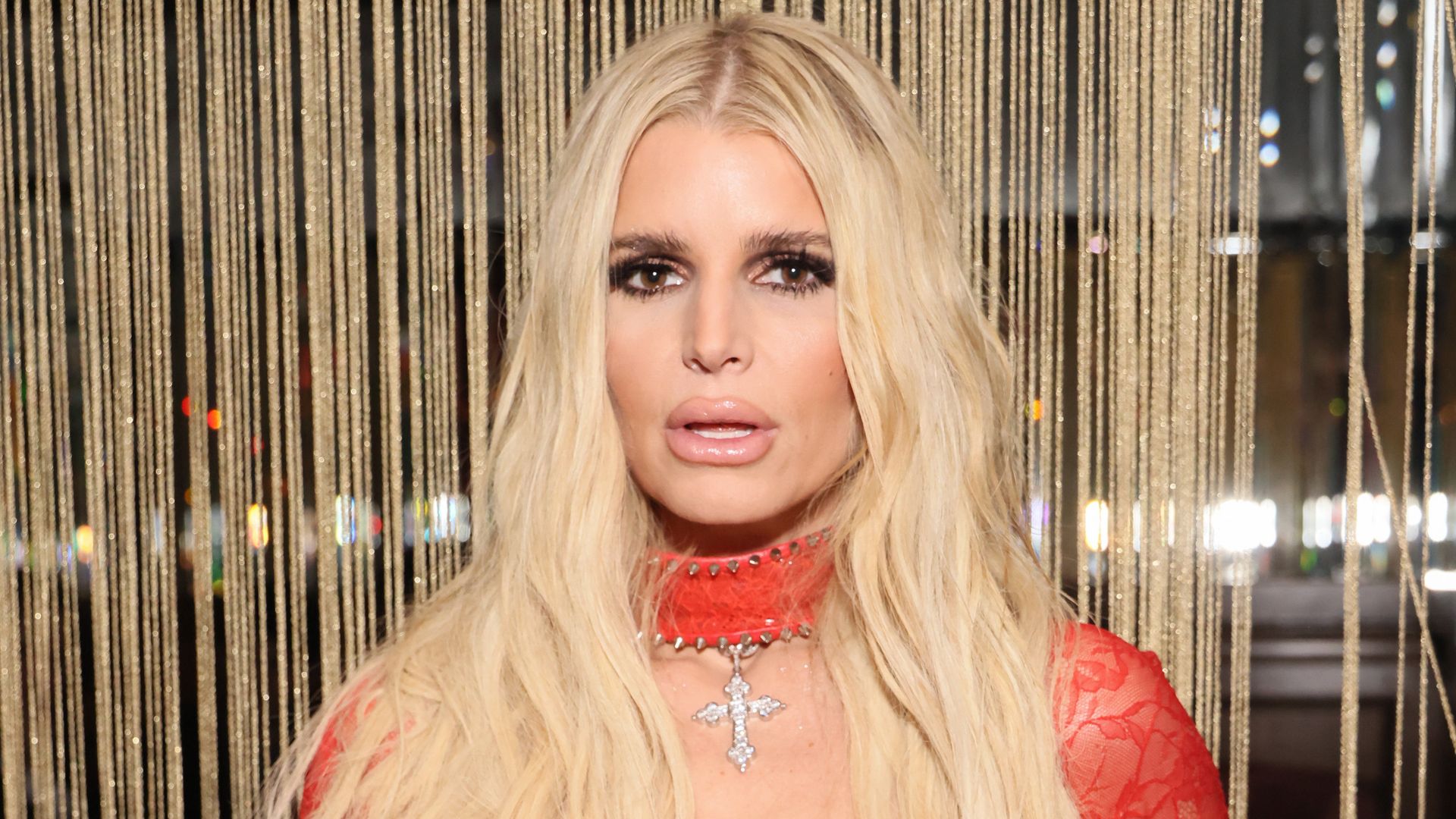 jessica simpson posing in red dress