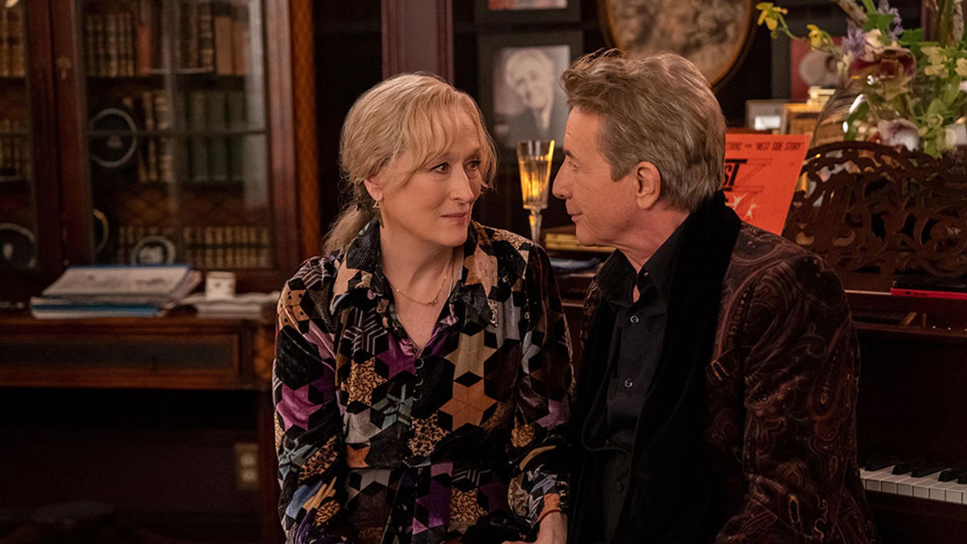 Loretta and Oliver sitting by the piano