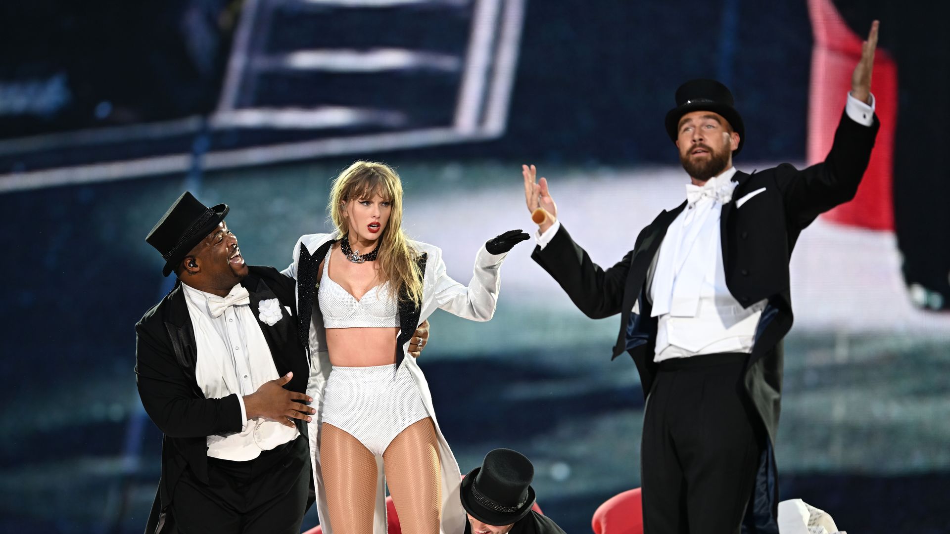 Taylor Swift is joined on stage by Travis Kelce (R), during "Taylor Swift | The Eras Tour" at Wembley Stadium on June 23, 2024 in London, England