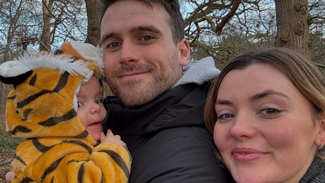 family of three on walk outside 