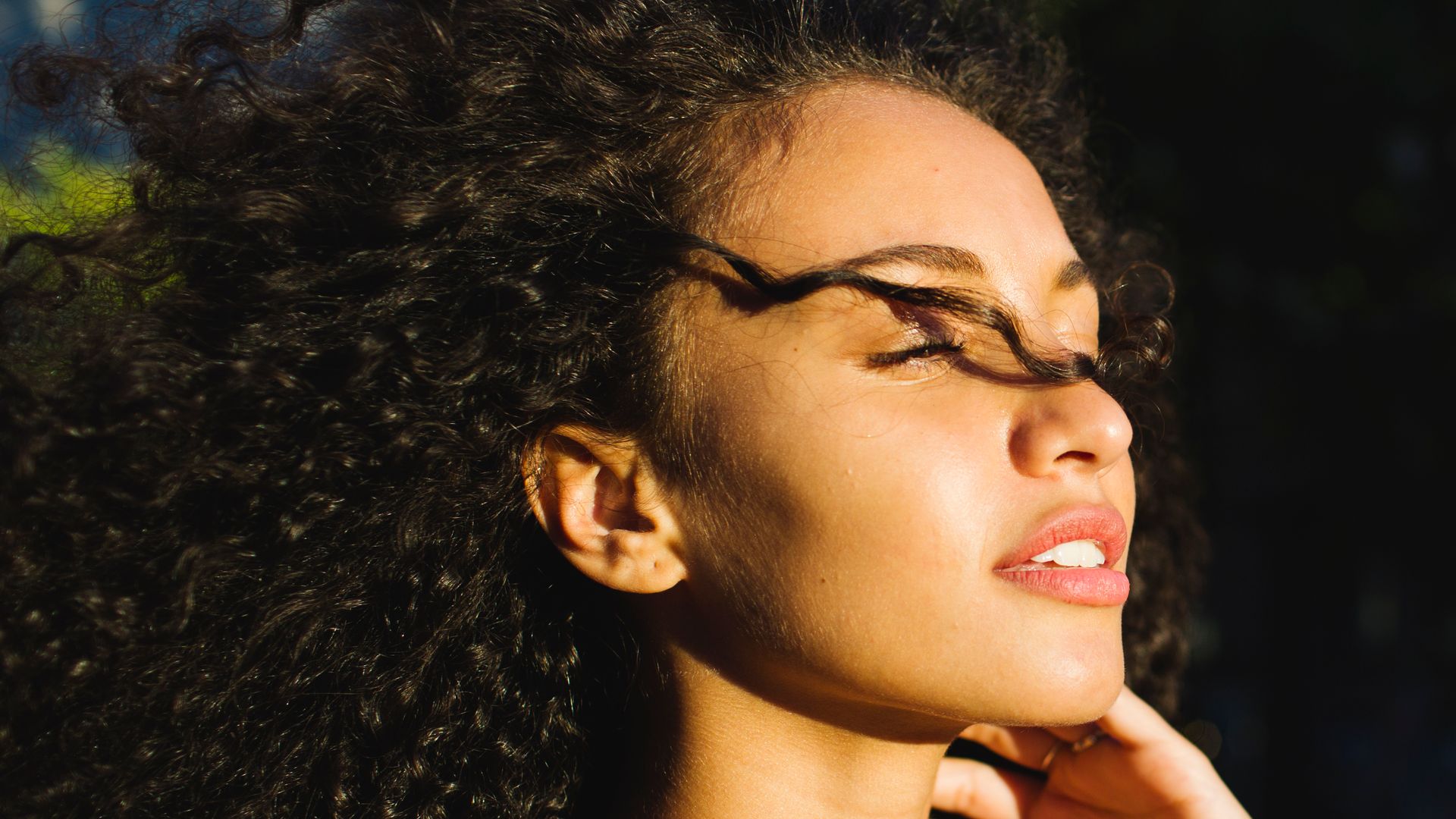 Beautiful woman looking refreshed in the sunlight