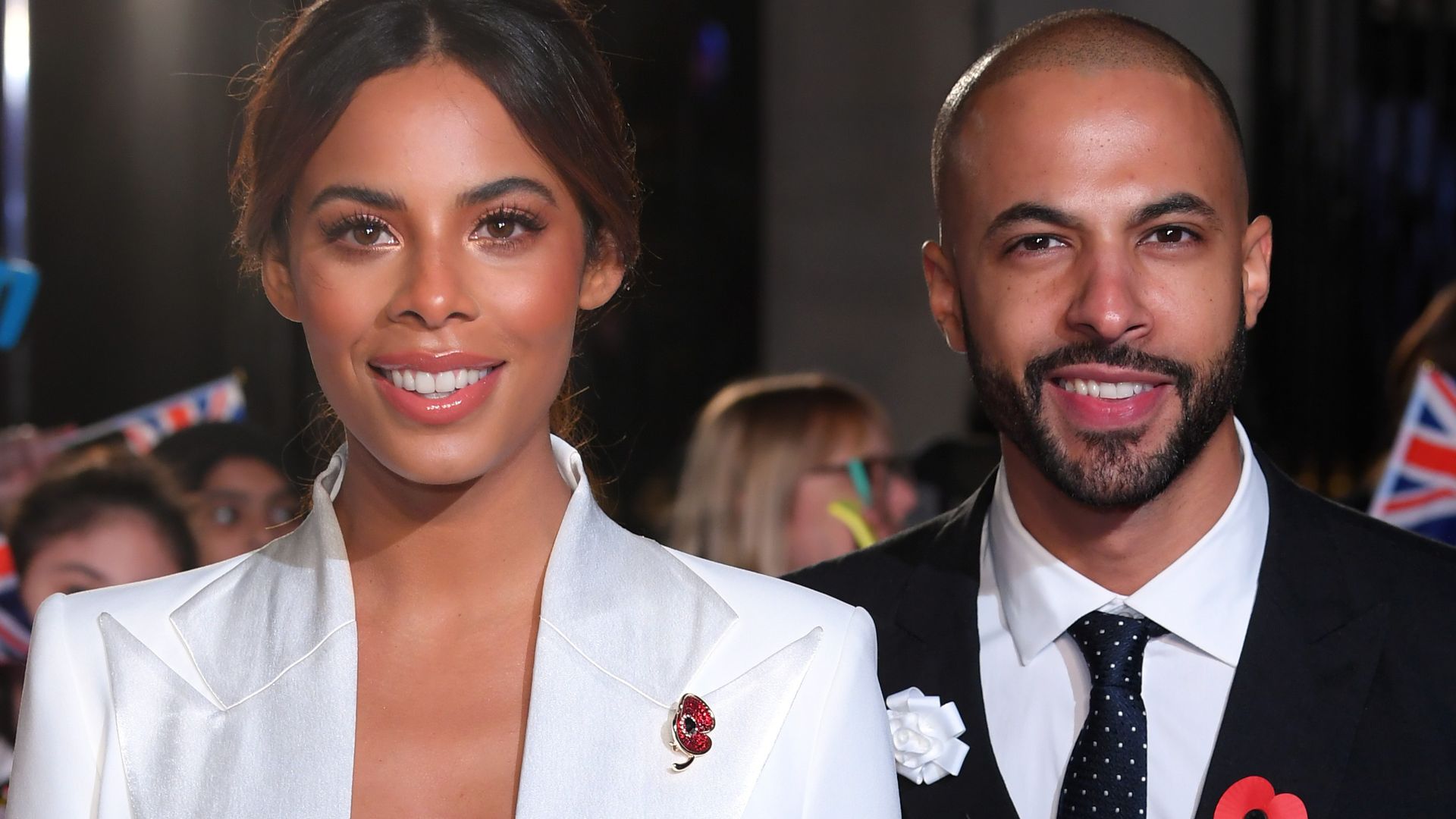 Rochelle Humes wearing a white jumpsuit on the red carpet with Marvin Humes