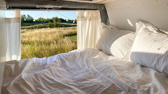 a bed inside a camper van