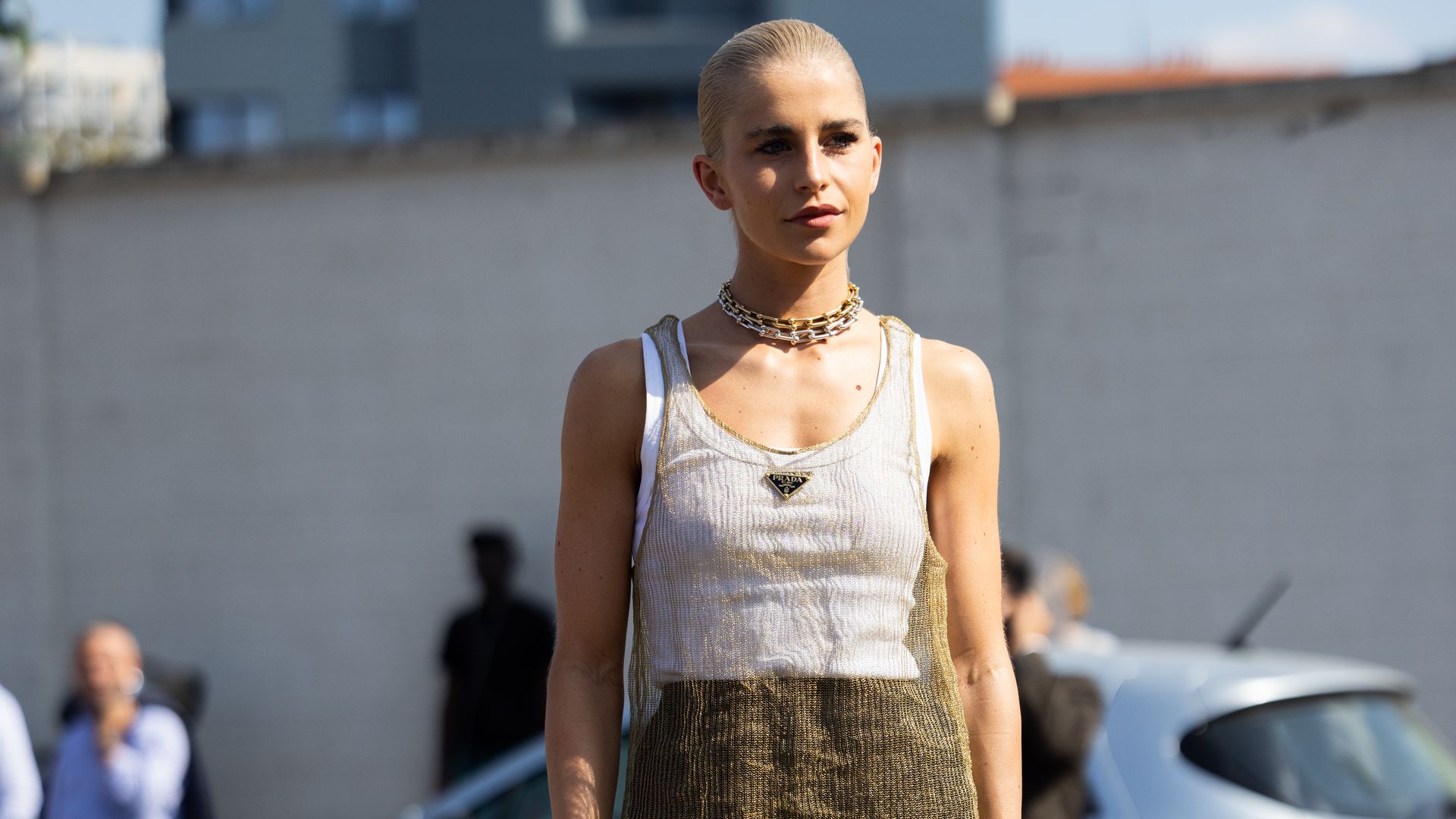 Caroline Daur is seen wearing Prada see-through dress with white tank top and panties and a chain neckless outside Prada show during the Milan Fashion Week - Womenswear Spring/Summer 2023