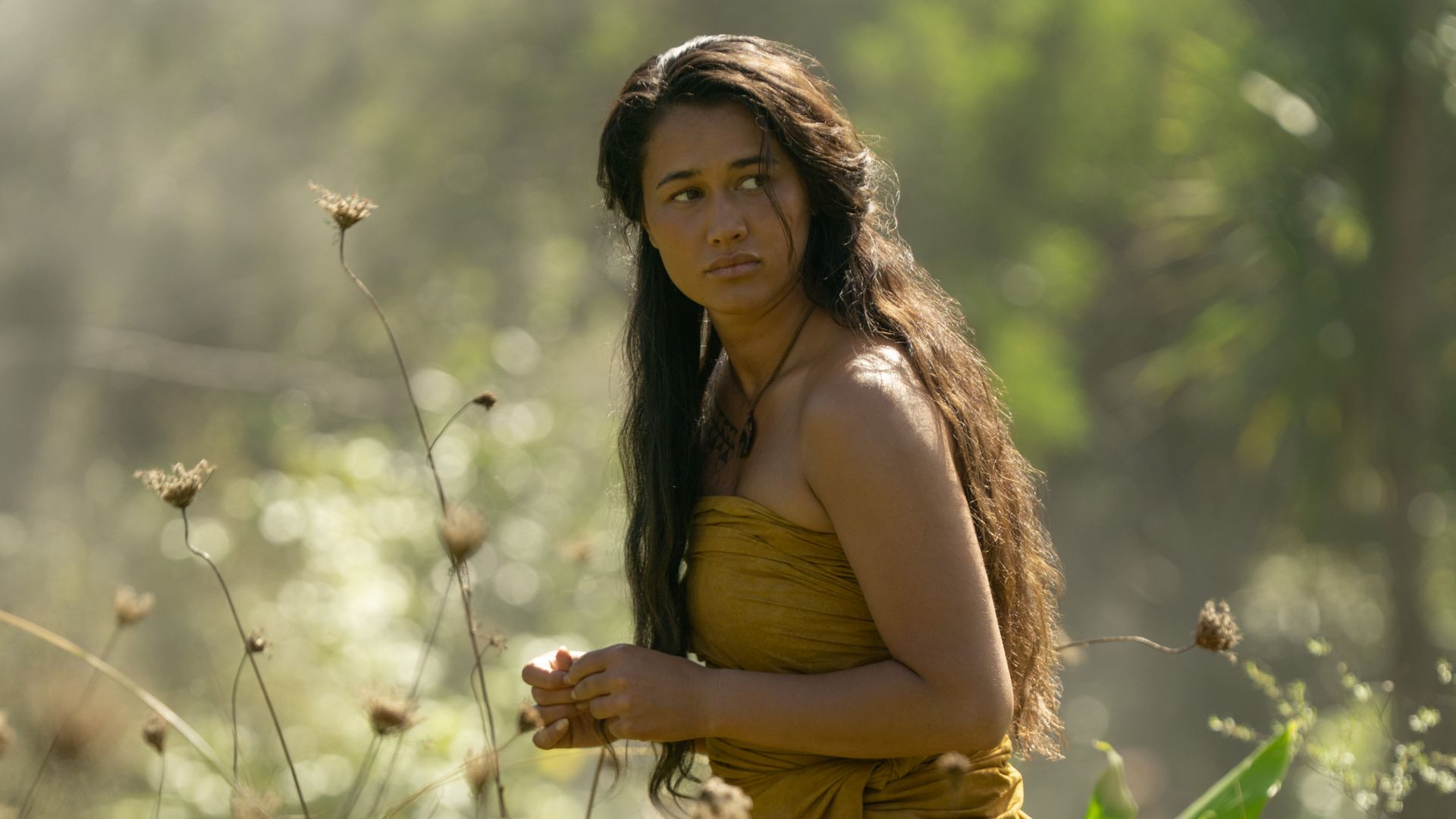 woman standing in field of flowers