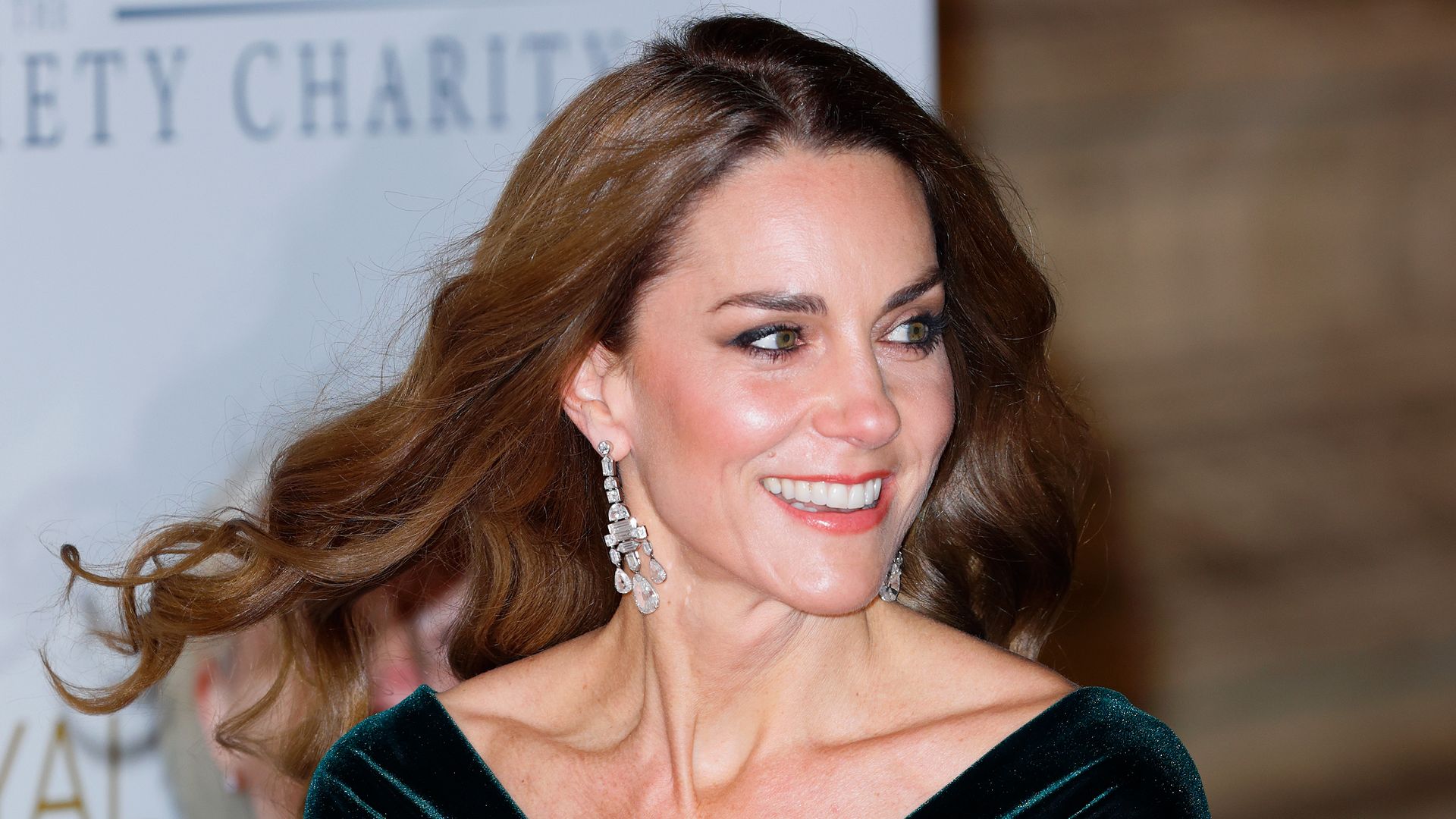 Kate wearing green velvet dress and sparkly earrings