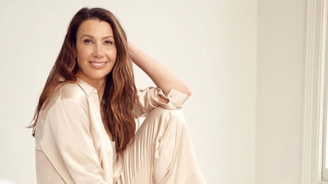 Woman with long hair in silky pyjamas 