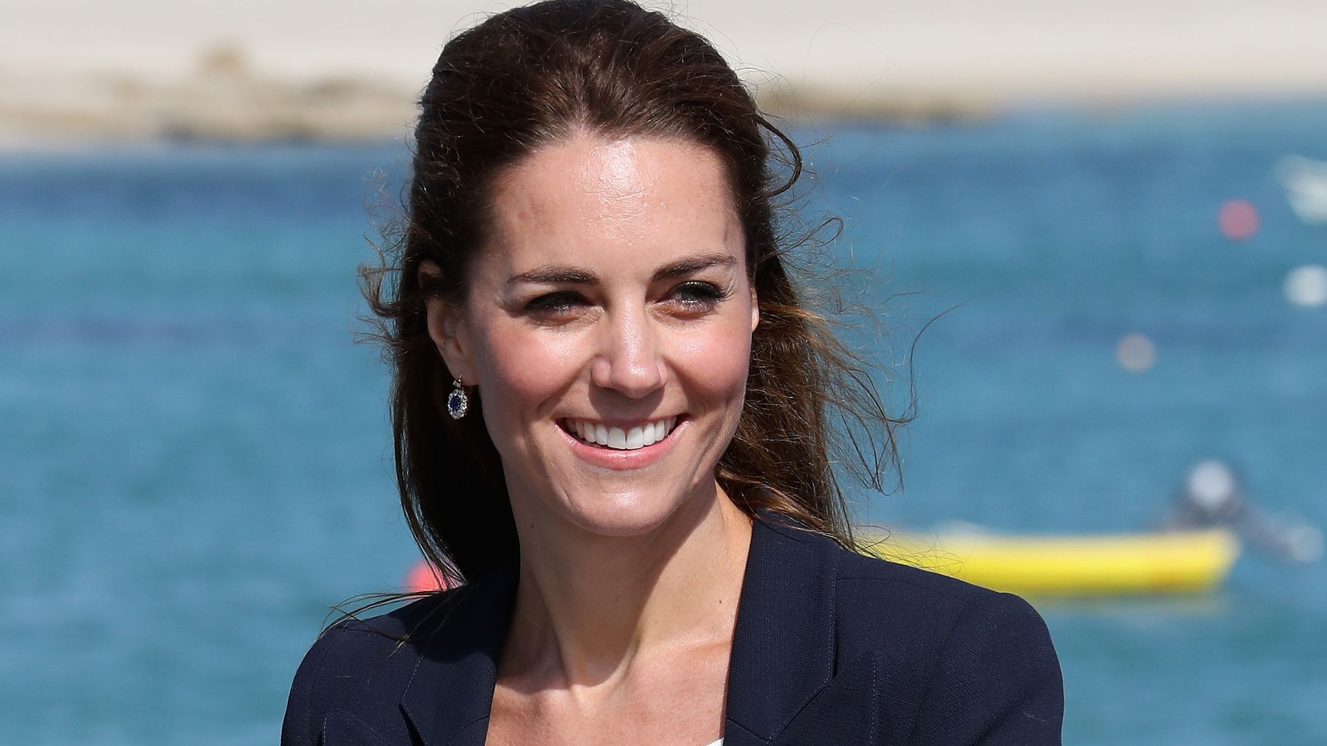 Kate Middleton smiling in front of the sea