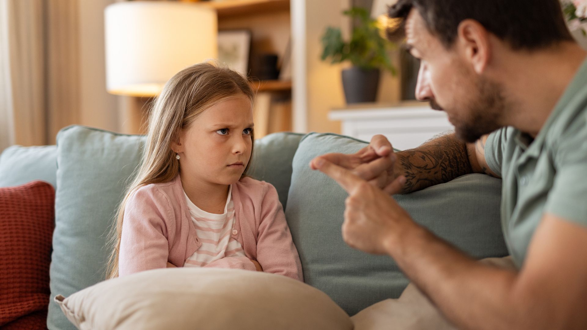 Displeased Father Having a Conversation With His Daughter About Her Behavior at Home