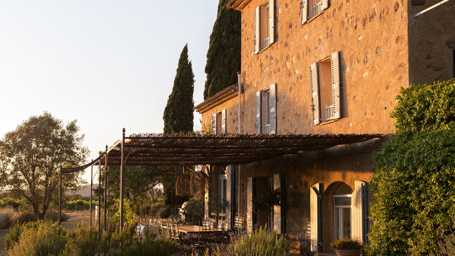 The outside of Domaine Mirabeau Provençal manor house in golden houe
