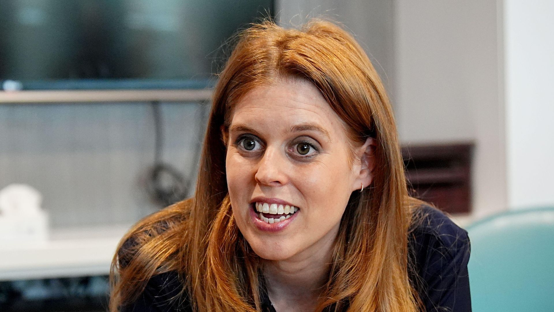 Princess Beatrice sitting in a cancer ward