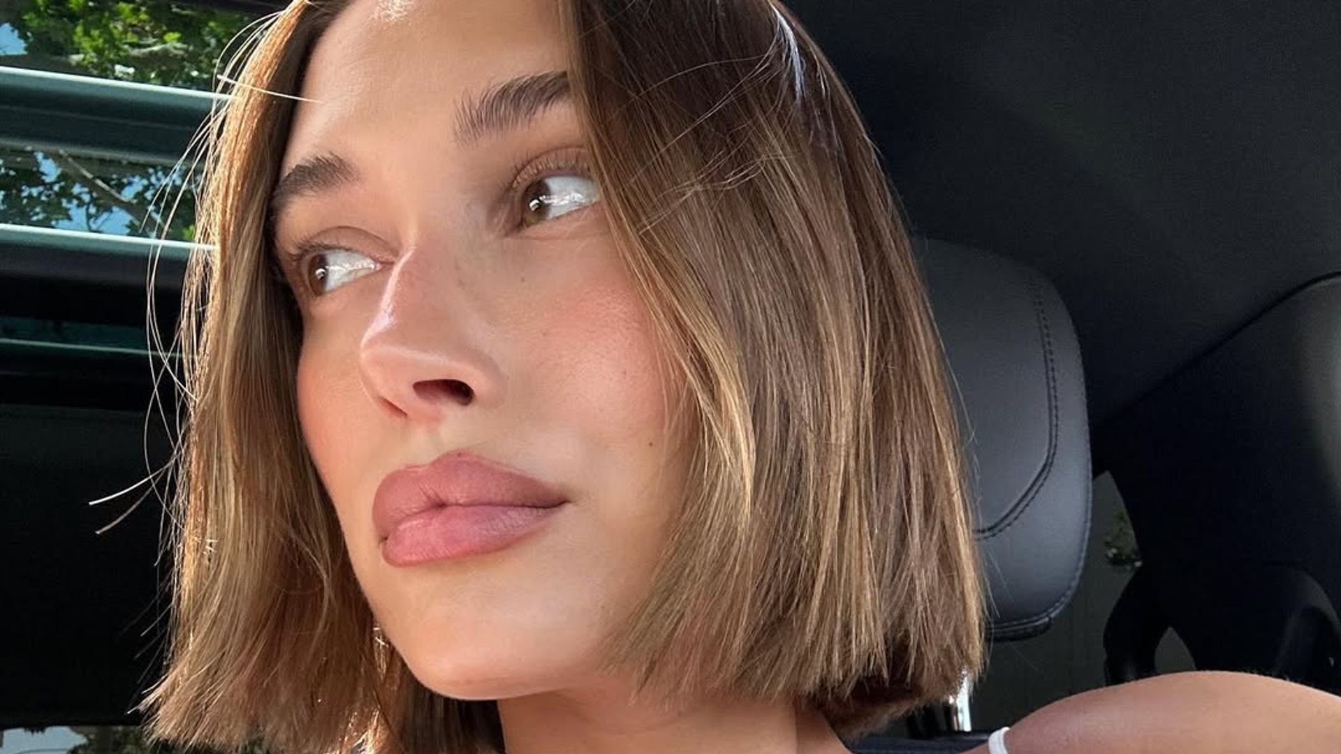 Hailey Bieber taking a selfie in a car