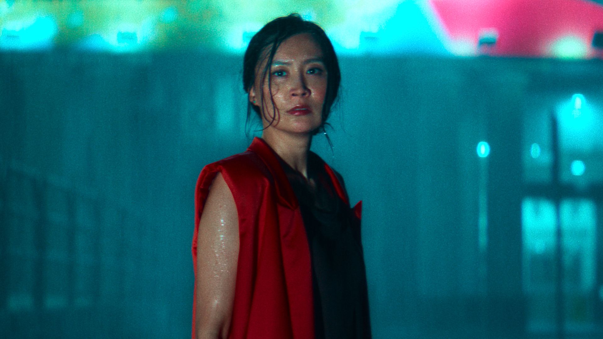 woman standing in the street in rain