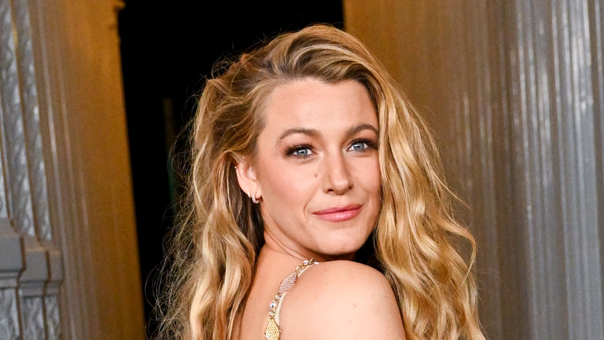 Blake Lively shows Ryan Reynolds what he's missing in bronzed chainmail dress