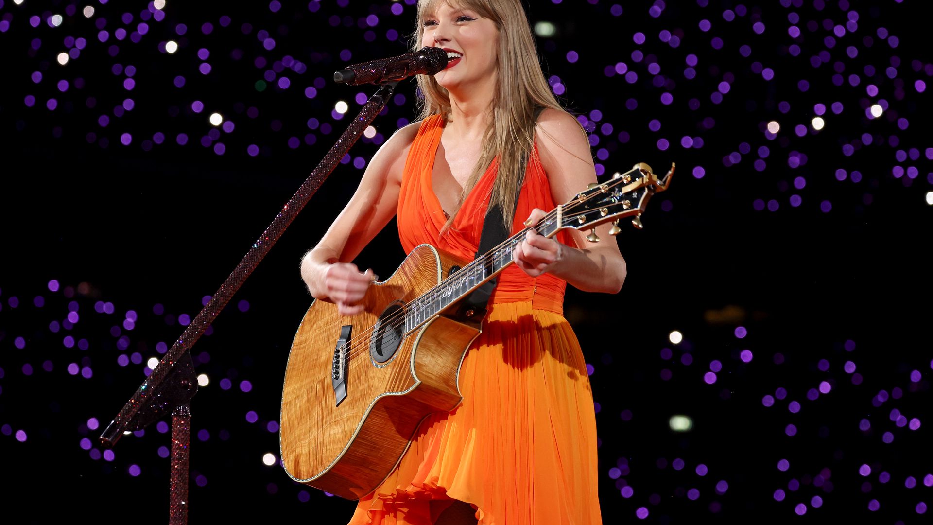 Taylor Swift wore an orange dress during "Taylor Swift | The Eras Tour" at Wembley Stadium in London back in 2024