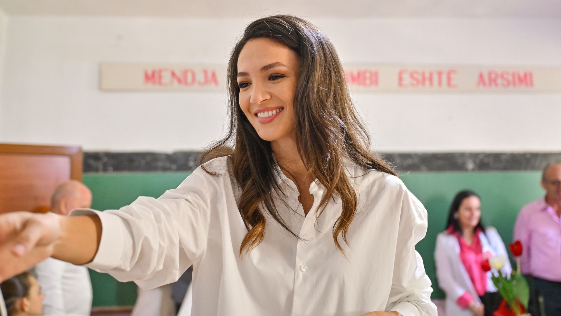 Blerta Celibashi handing gifts