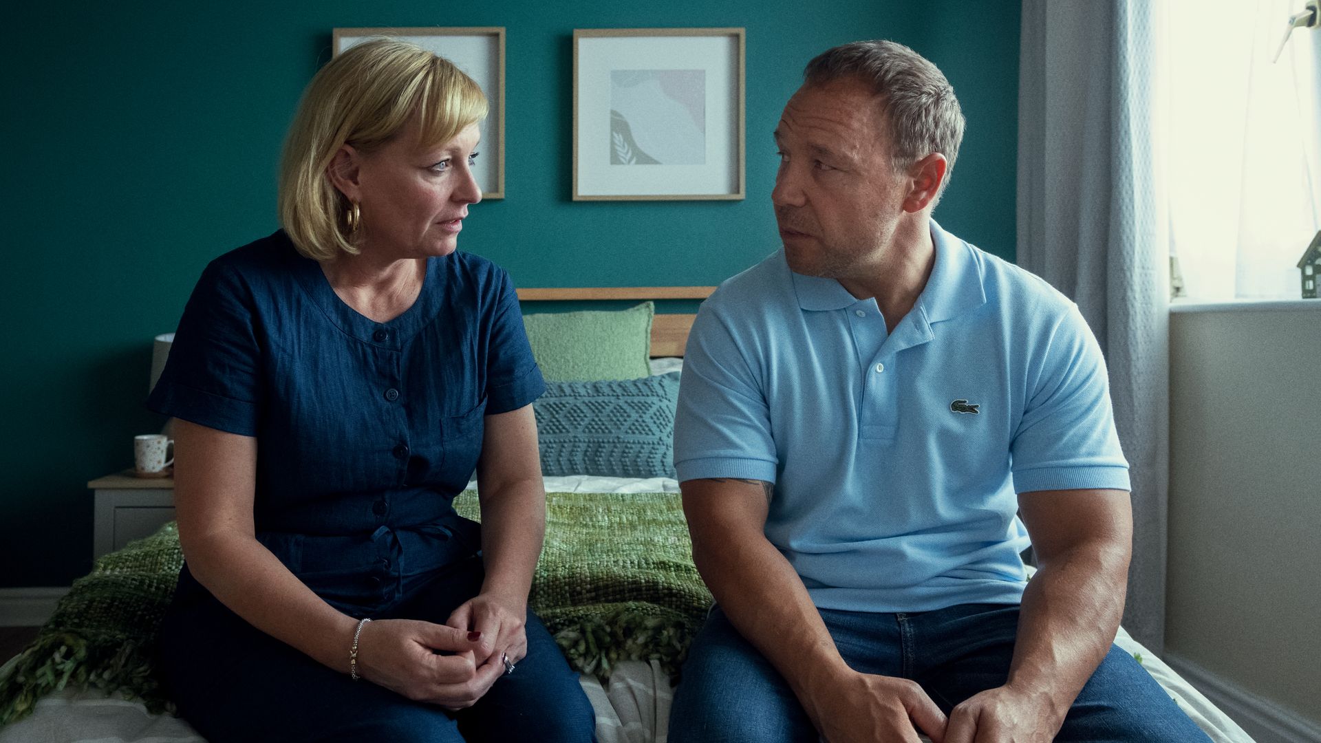 Christine Tremarco and Stephen Graham sitting on a bed in Adolesence
