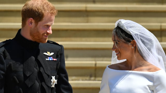 Prince Harry smiles at his new wife the Duchess of Sussex on the steps of St George's Chapel