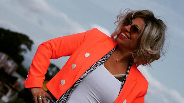 Woman in bright jacket smiling in