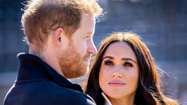 Meghan looking up at harry looking serious