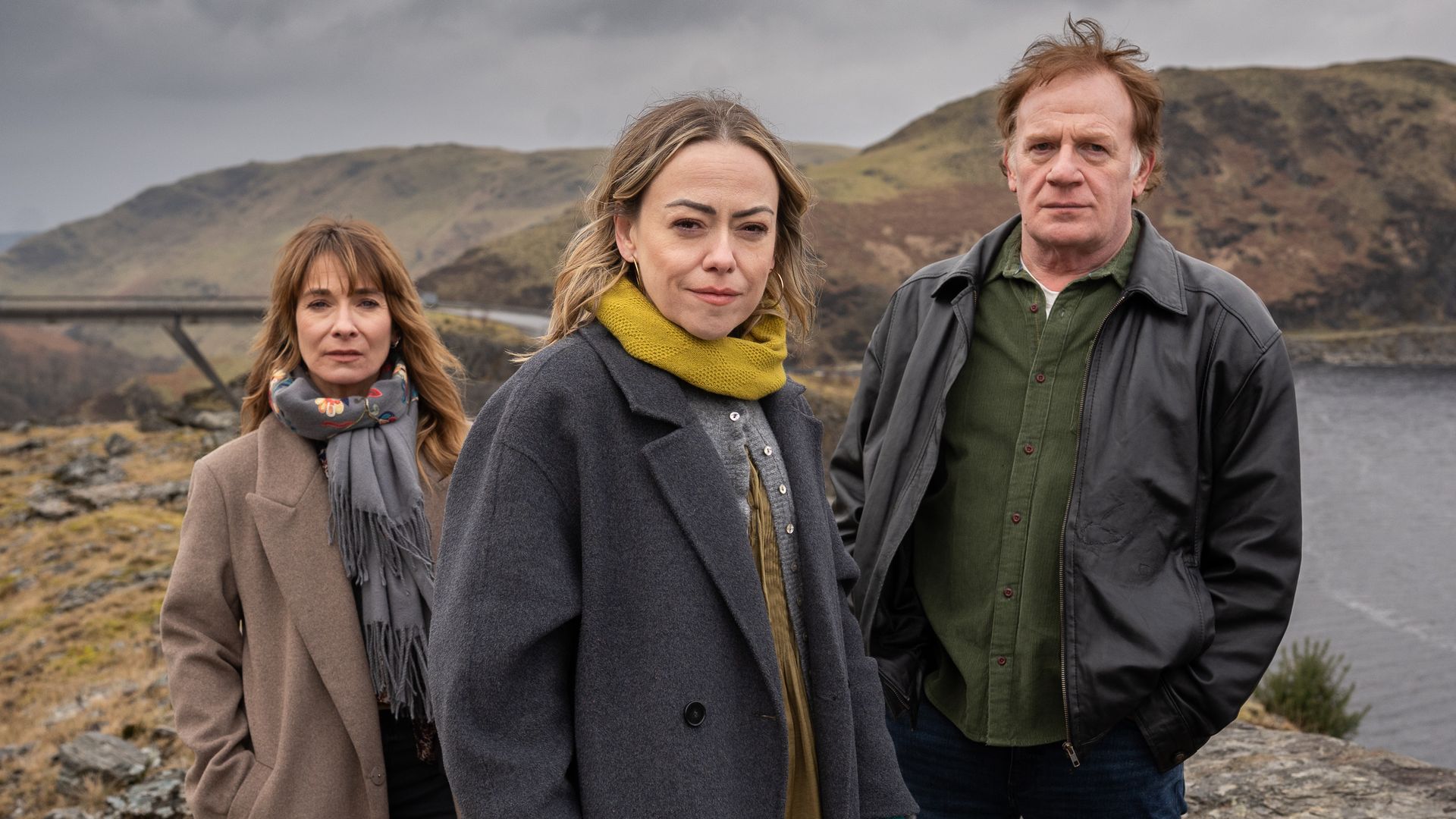group of people standing by water