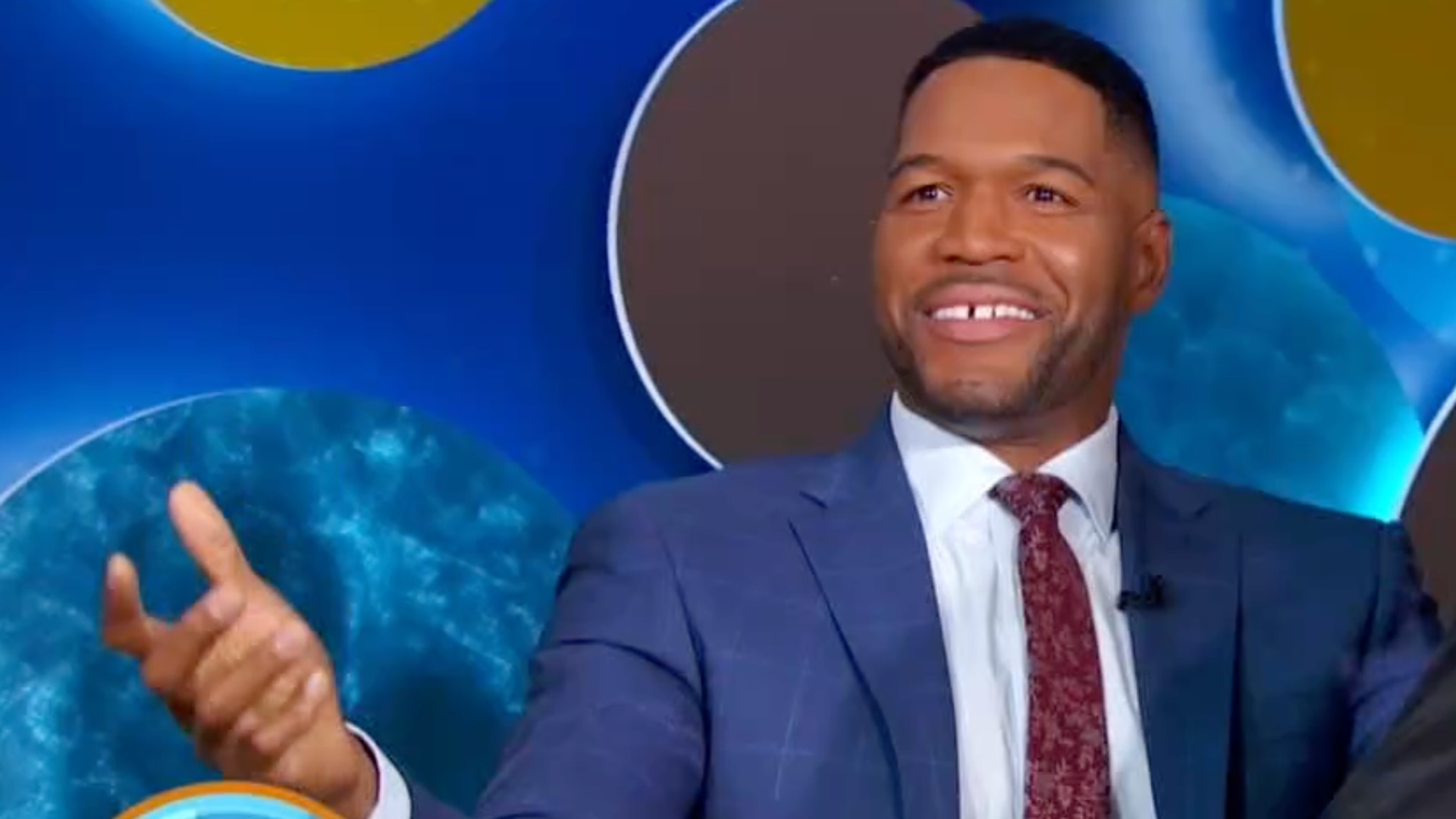 Michael Strahan on GMA set throwing hands up
