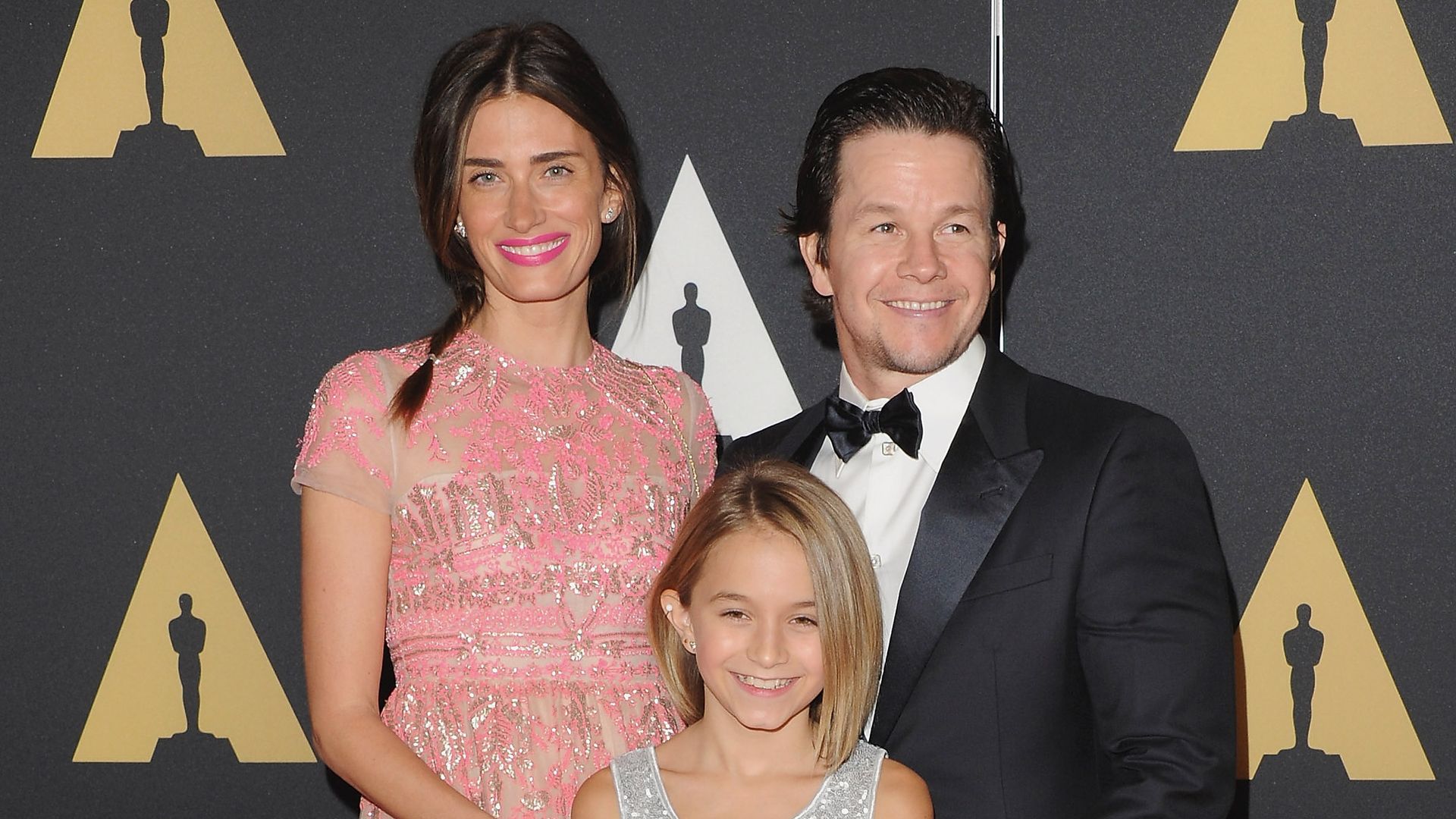 Model Rhea Durhamin a pink dress, daughter Ella Wahlberg in silver dress, and actor Mark Wahlberg in suit, at the Academy Of Motion Picture Arts And Sciences' Governors Awards 