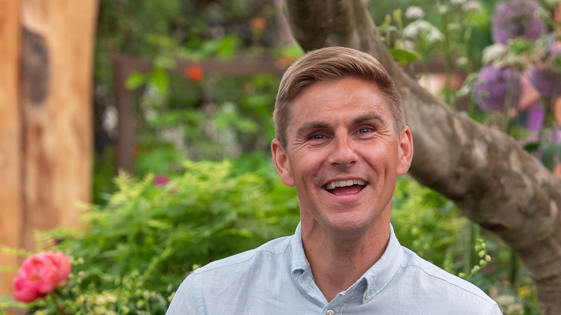 smiling man in wheelchair in garden