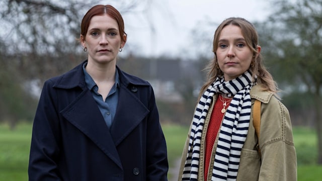 two women standing in park