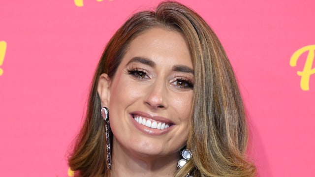 Stacey Solomon smiling in a black dress