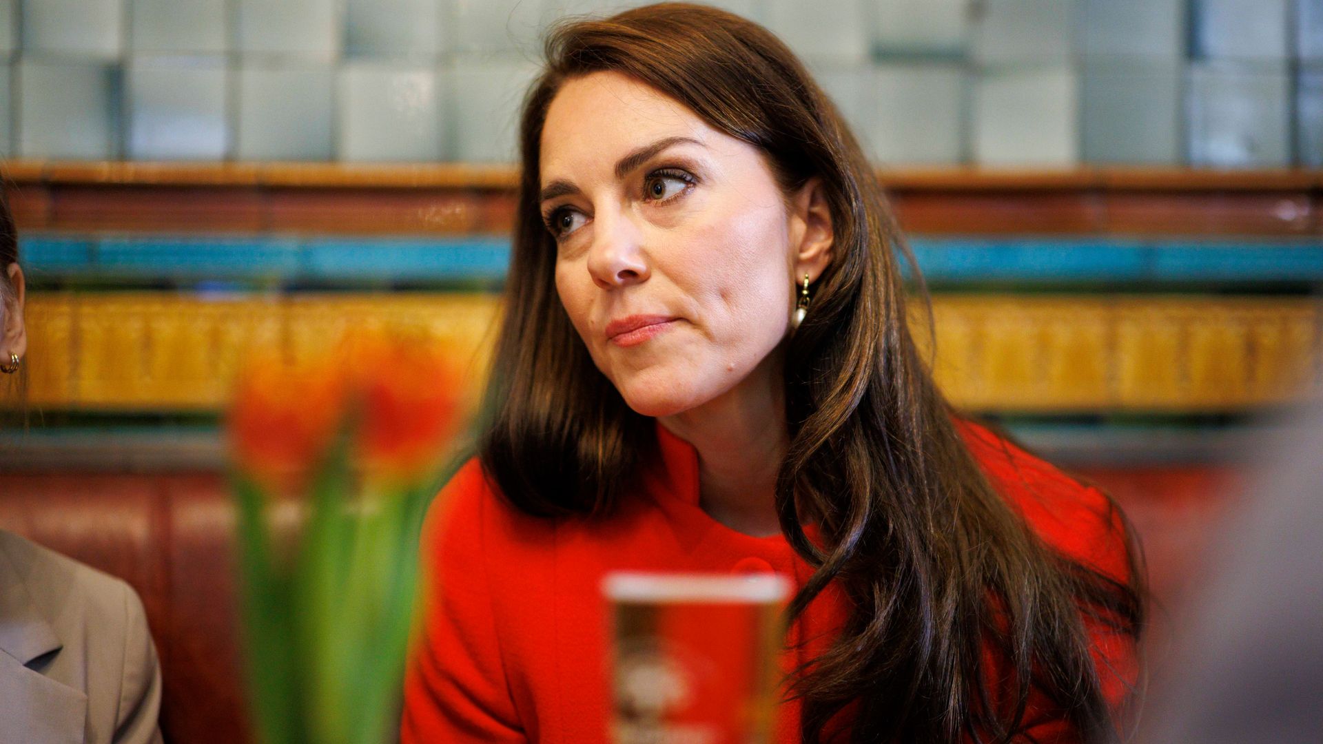 Kate Middleton in red with stern expression