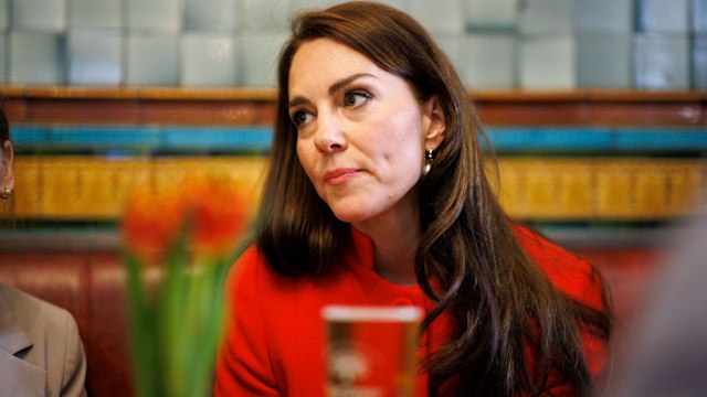 Kate Middleton in red with stern expression