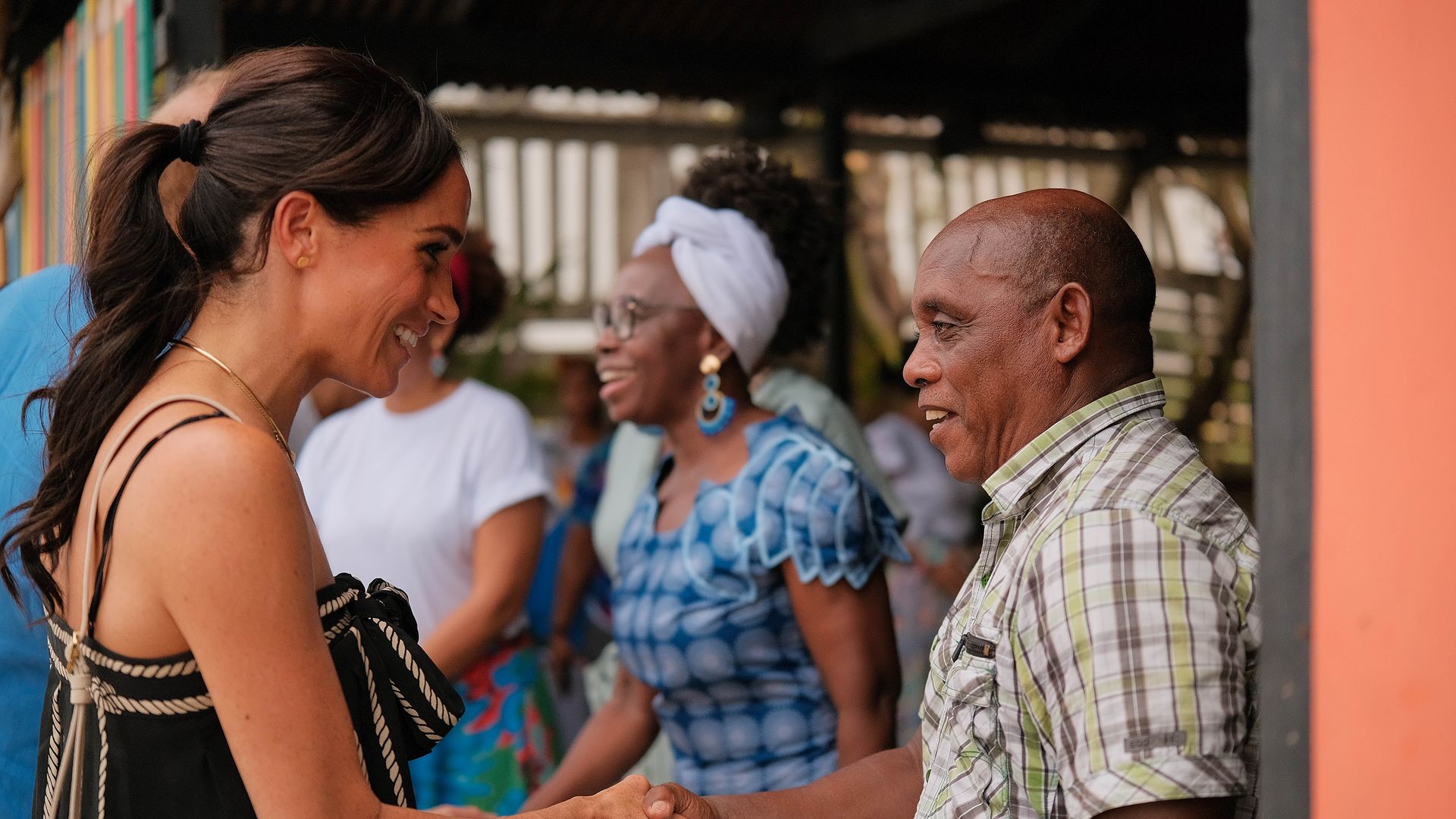 Meghan Markle shaking hands with a man