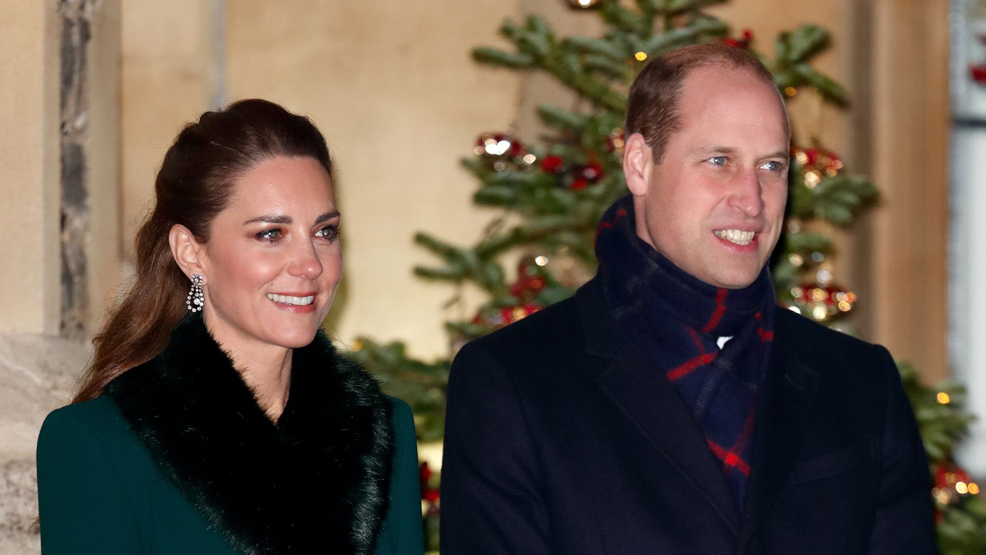 William and Kate at Windsor Castle with Christmas tree behind them