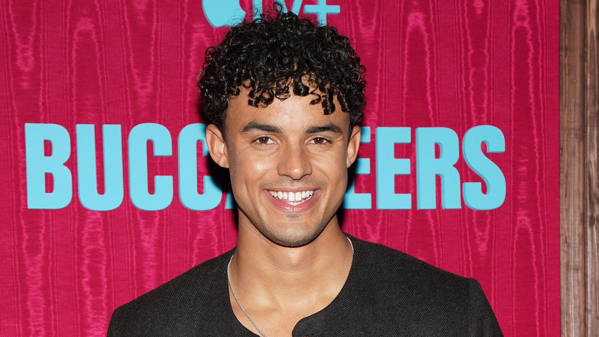 young male actor posing on red carpet