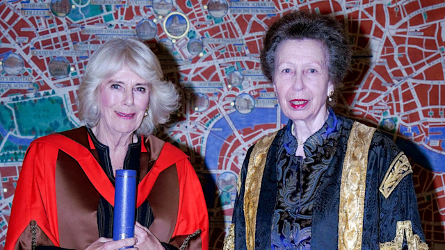 Queen Camilla is presented with an honorary doctorate of literature from the University of London by the University's Chancellor, Princess Anne, Princess Royal