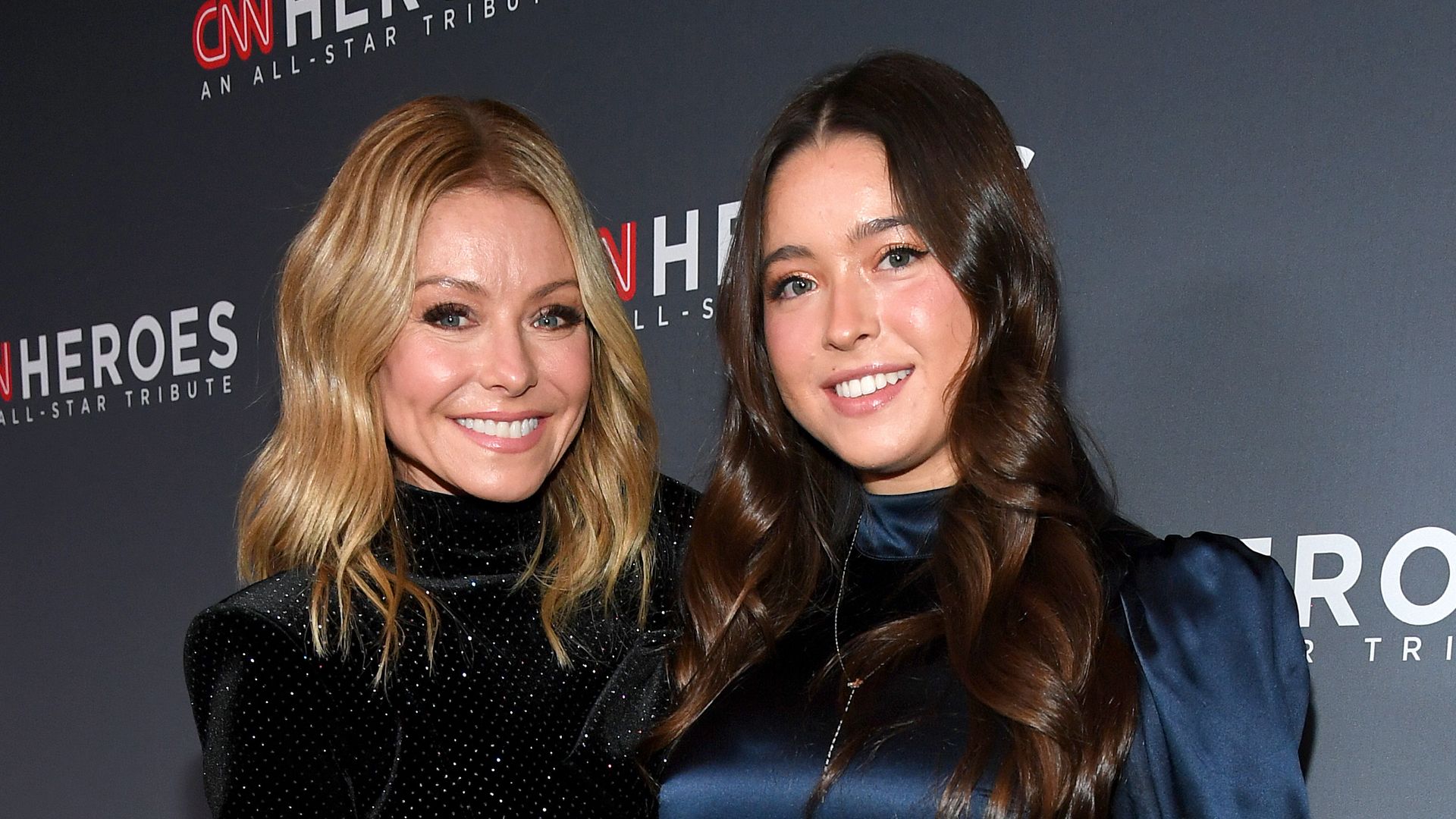 Kelly Ripa in black dress and Lola Grace Consuelos in blue dress at CNN Heroes at American Museum of Natural History