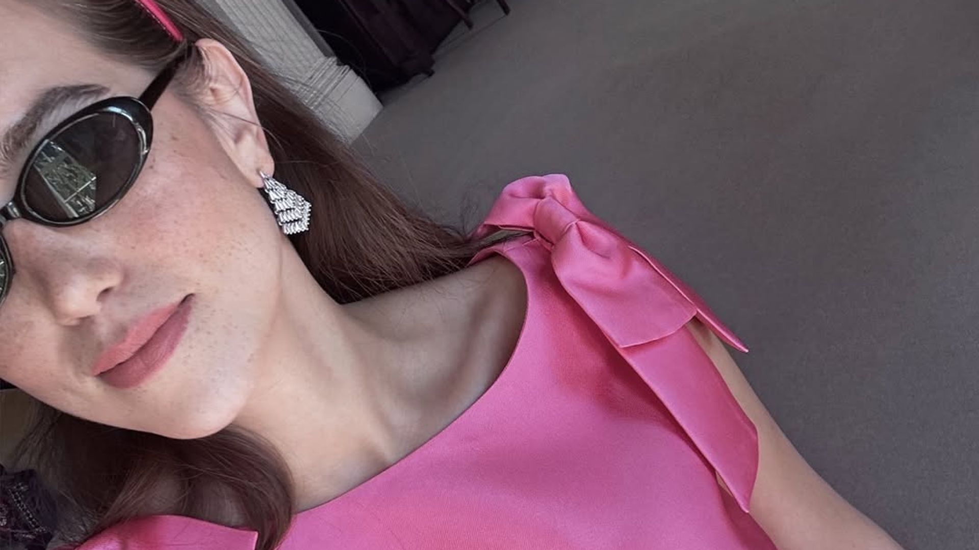 Fashion Tech Journalist Natalie Salmon wears pink dress and black sunglasses