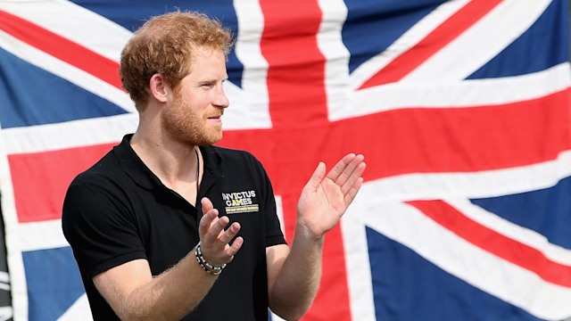 Prince Harry standing in front of a Union Jack