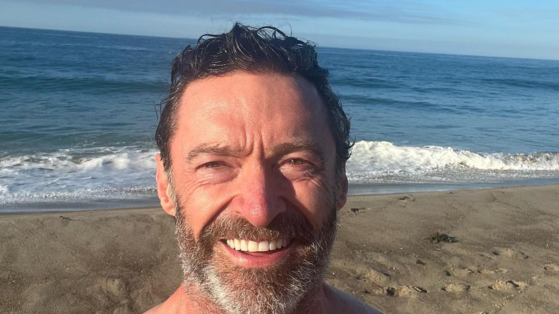 Hugh Jackman shirtless selfie on the beach