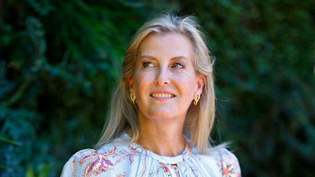 Sophie, Duchess of Edinburgh by living wall in blue patterned dress